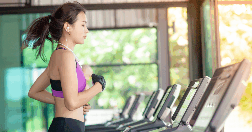Woman jogging on a treadmill as part of a low-impact workout routine for sustainable weight loss on Semaglutide or Tirzepatide.