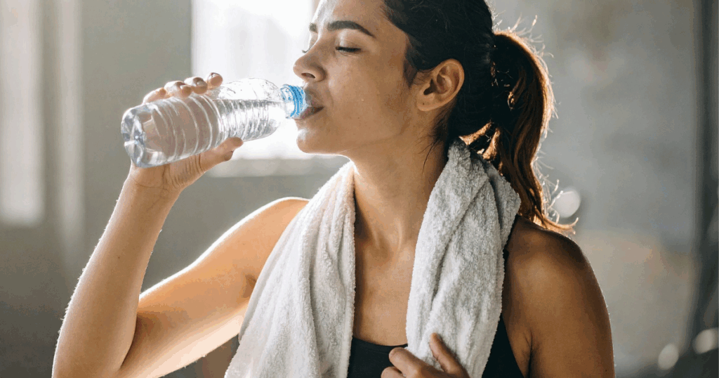 Woman hydrating after exercise while following a Semaglutide or Tirzepatide fitness plan to support energy and recovery